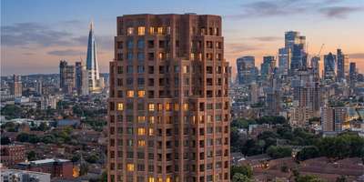 Aerial view of the Bermondsey Heights tower at twilight, with the Shard and the City behind