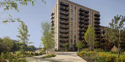 Hayes Village apartment building beside landscaped paths